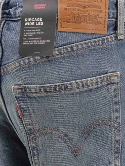 Jeans gamba larga con cassa toracica
